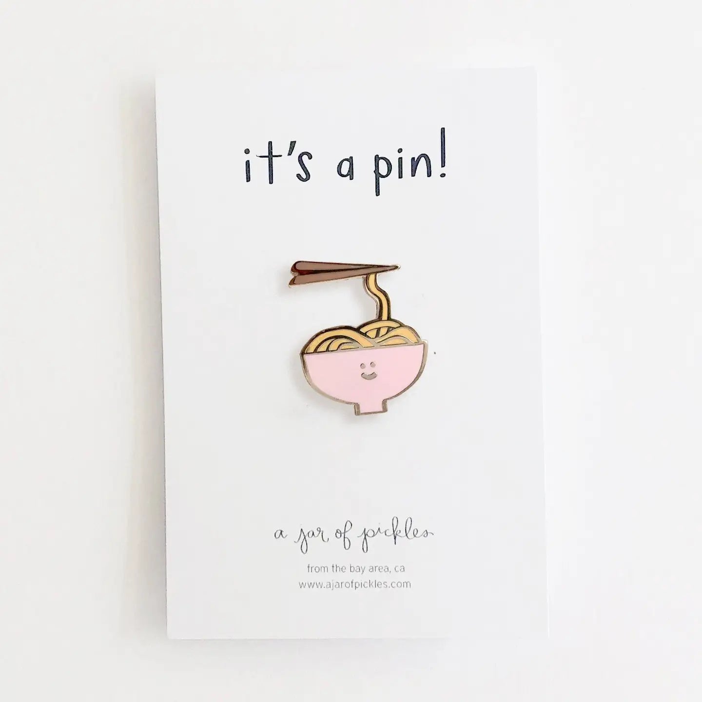 pin of smiley bowl of noodles in pink bowl, on white background