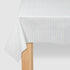 White tablecloth with thin blue stripes on a wooden table