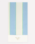 A pale blue stripe paper tablecloth with green stripes, branded with 'Meri Meri' and a signature line below.