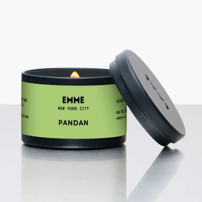 Candle in a green and black container with "pandan" text and branding on a white background