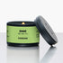 Candle in a green and black container with "pandan" text and branding on a white background