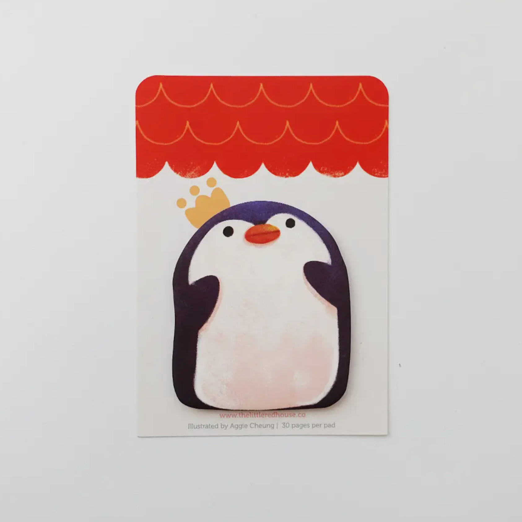 A die cut sticky note with a vibrant penguin design and a crown on top of the penguin's head.