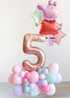 Balloon arrangement with a number '5' and a character balloon on a white background