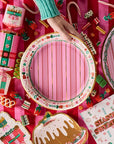 Decorative items including a pink plate, cookies, and a letter to Santa on a pink background.