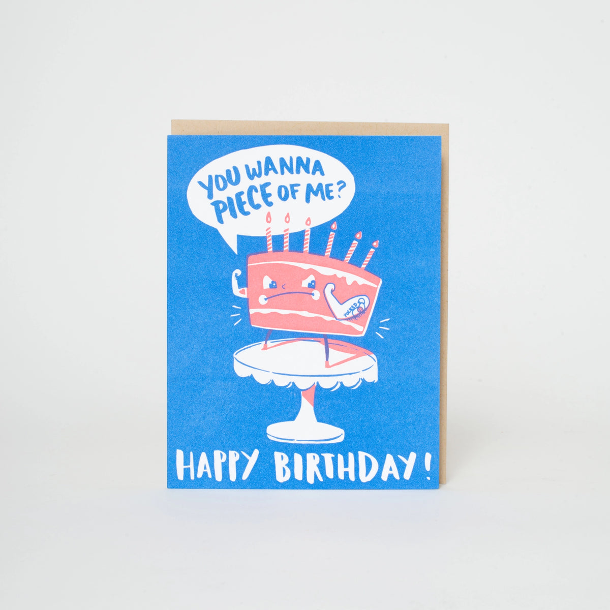 A blue birthday card with a cartoon slice-of-pie cake on a pedestal and the text 'YOU WANNA PIECE OF ME?' and 'HAPPY BIRTHDAY!'.
