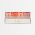 A set of 4 bow candles in pink and coral gradient.