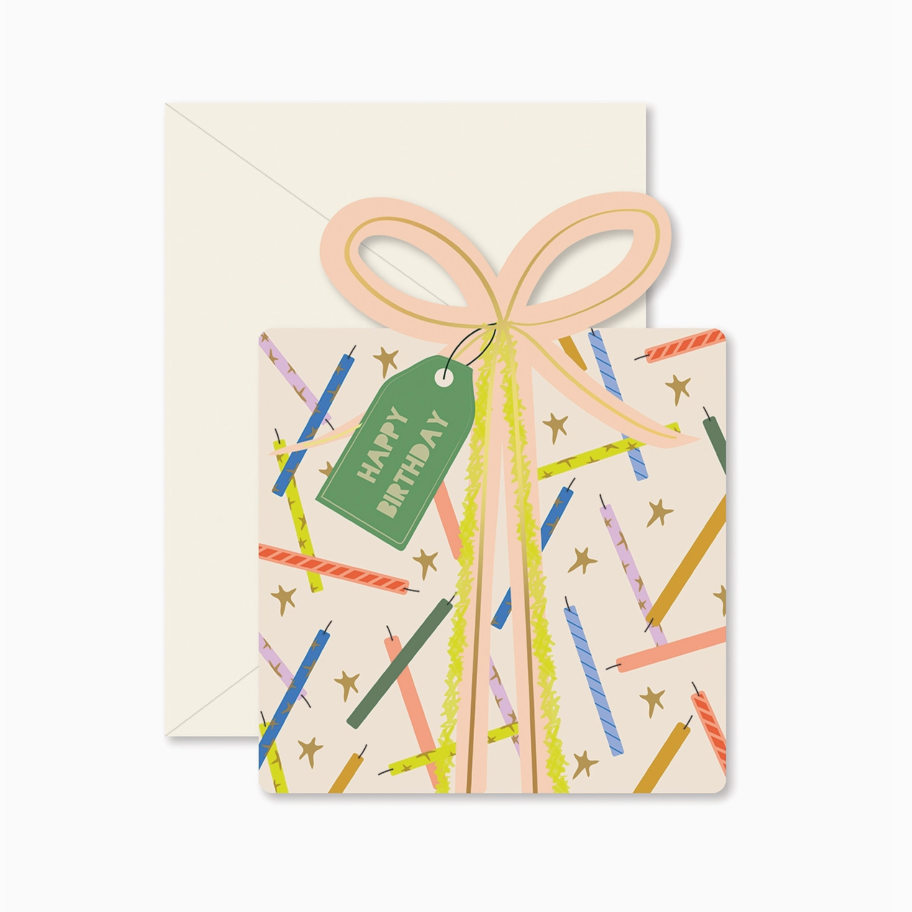A folded birthday card with a die-cut shape, featuring a colorful design with birthday candles and stars, and a pink ribbon bow on top. It includes a matching envelope.