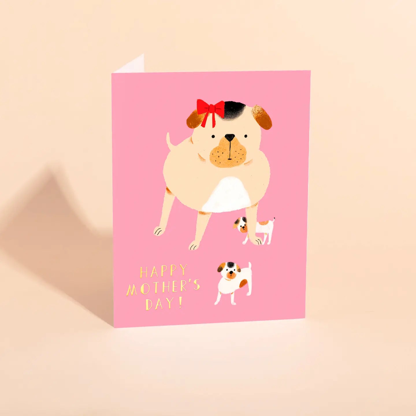 A Mother's Day greeting card featuring an illustration of a pug dog with a red bow on its head, and two smaller images of pug pups. The card has a pink background and the text 'Happy Mother's Day' is visible.