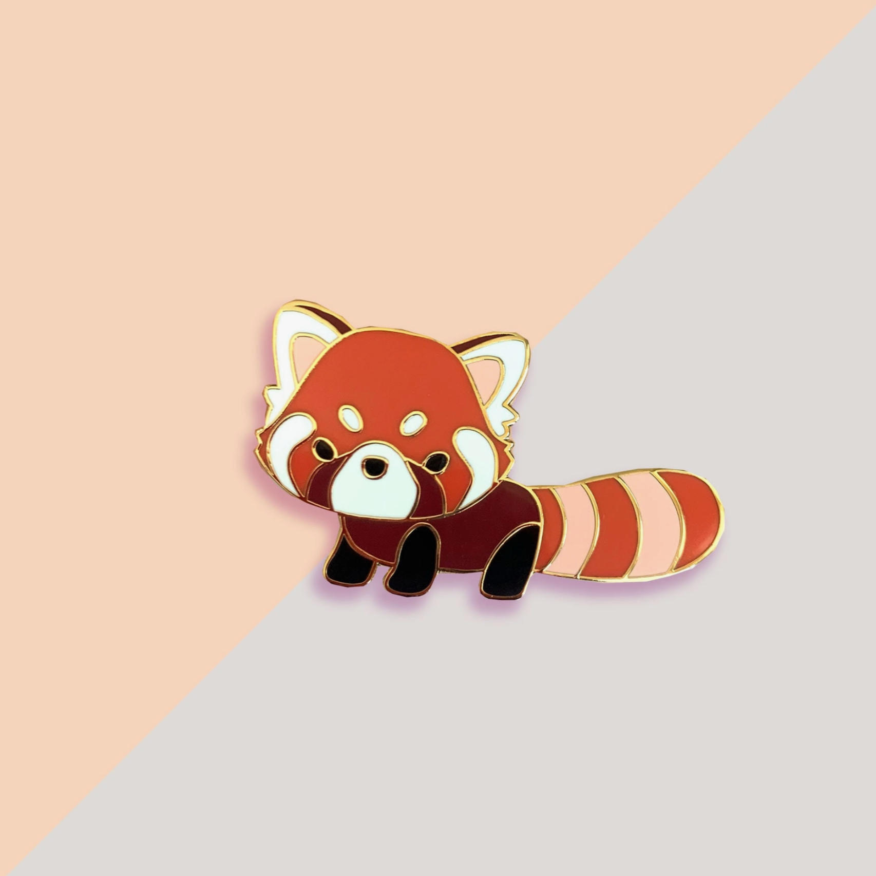 A red panda pin with gold trim