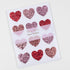 red and pink glitter heart stickers on white background