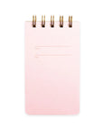 A pink covered notebook wiht a ring binding