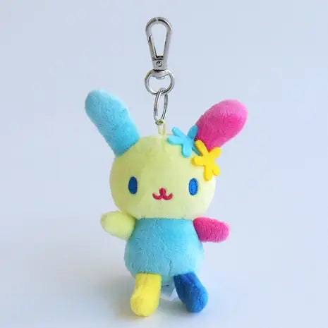 Plush keychain with a colorful bunny Sanrio character on a light blue background