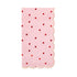 Pink paper napkin with scalloped edge and red heart pattern on a white background