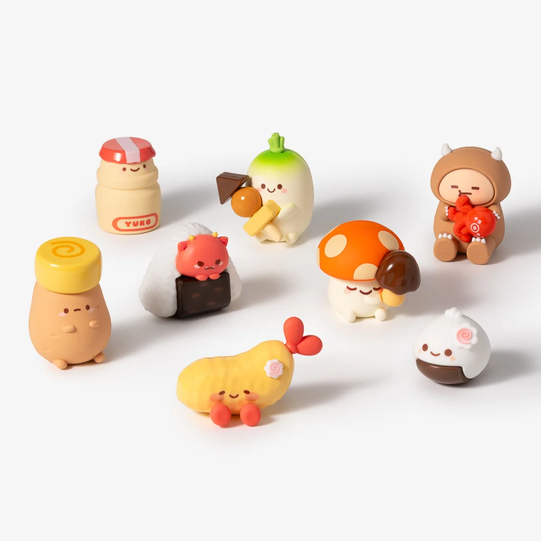 set of 8 mini vinyl characters of smoko friends dressed as various snacks, on white background