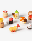set of 8 mini vinyl characters of smoko friends dressed as various snacks, on white background