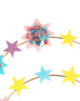 Colorful star-shaped headbands with confetti on a white background