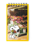 Notebook cover with Snoopy holding flowers and a flower shop in the background