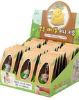 Display box of small animal keychains with a green background