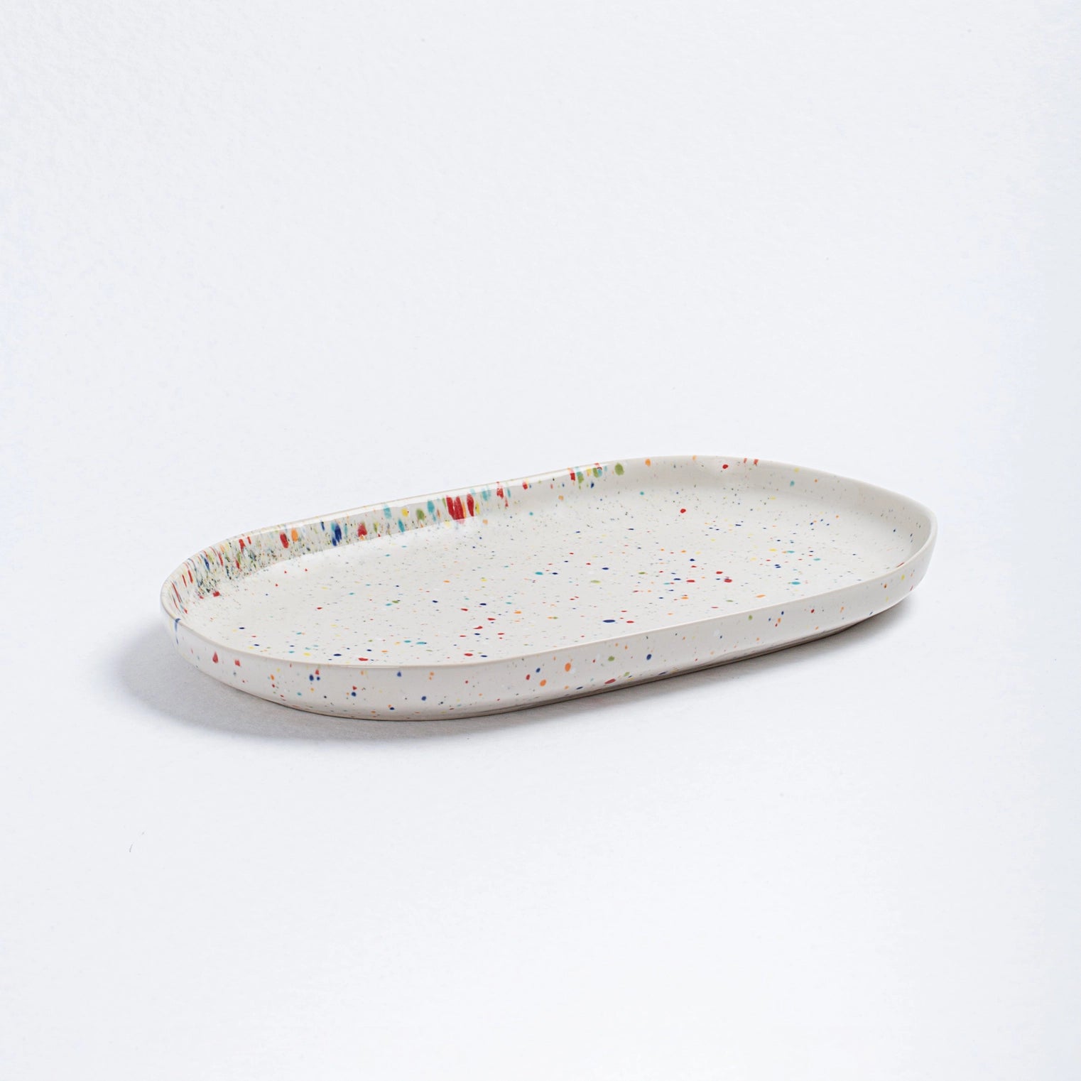 Speckled ceramic tray on a white background