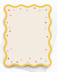 The back of a sprinkles themed notecard with scallop border and sprinkles along the edge