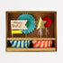 Colorful birthday party supplies including paper fans, a star, and striped cups in a box.