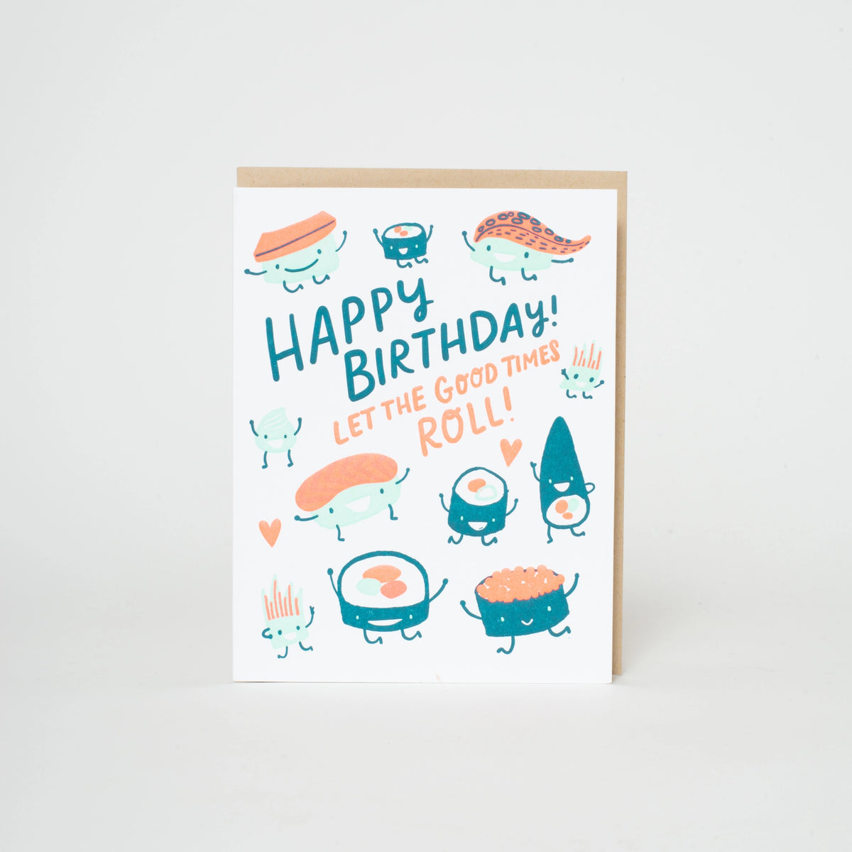 A white birthday card with a kraft envelope, featuring cute cartoon sushi characters and the text 'HAPPY BIRTHDAY! LET THE GOOD TIMES ROLL!' in teal and orange lettering.