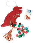 A piñata shaped like a T-Rex with red body, brown spots, and a copper foil detail on its back, with a string of confetti and two temporary tattoos attached.