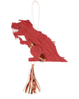 A piñata shaped like a T-Rex with red body, brown spots, and a copper foil detail on its back, with a string of confetti and two temporary tattoos attached.