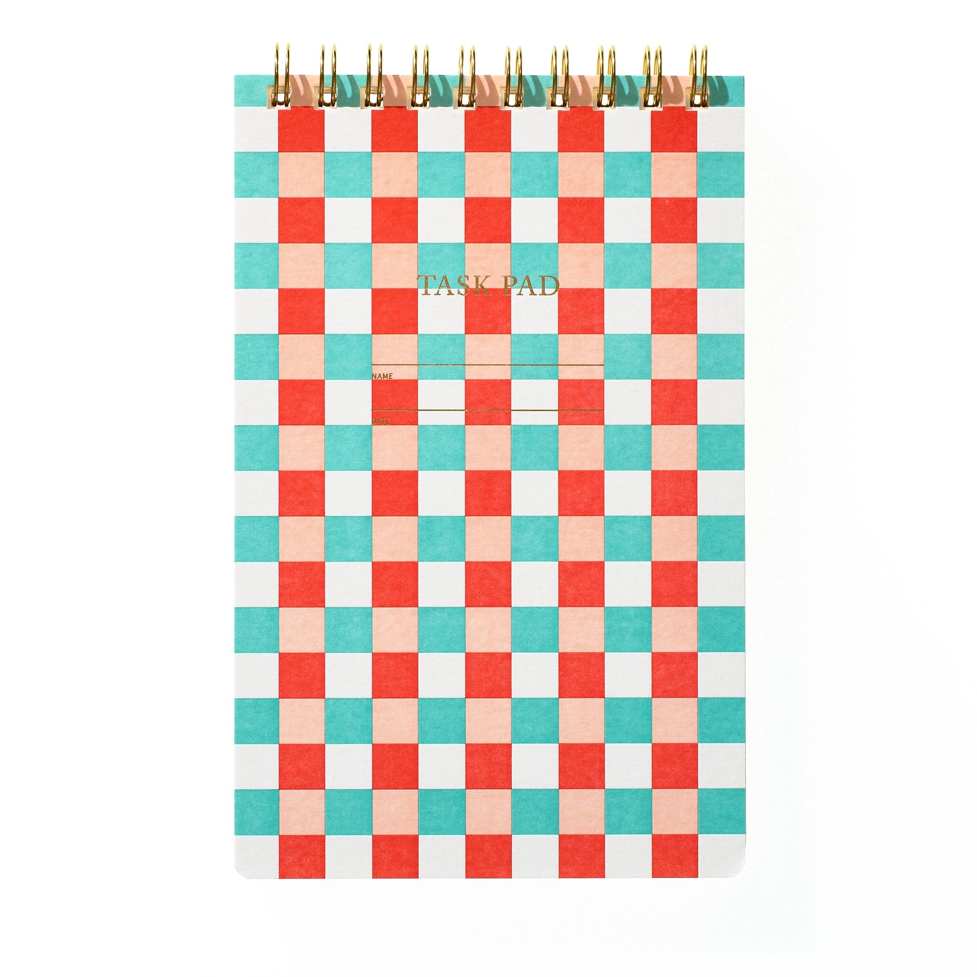 A spiral-bound task pad with a colorful checkerboard pattern in teal, coral, peach, and white, featuring gold metal spiral binding and gold foil text that reads 'TASK PAD'.