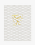 a grey with white dots print card with gold foil thank you text