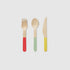 Set of wooden cutlery with colored handles on a light gray background