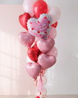 Red and pink large balloon bouquet featuring a vintage heart shaped cake