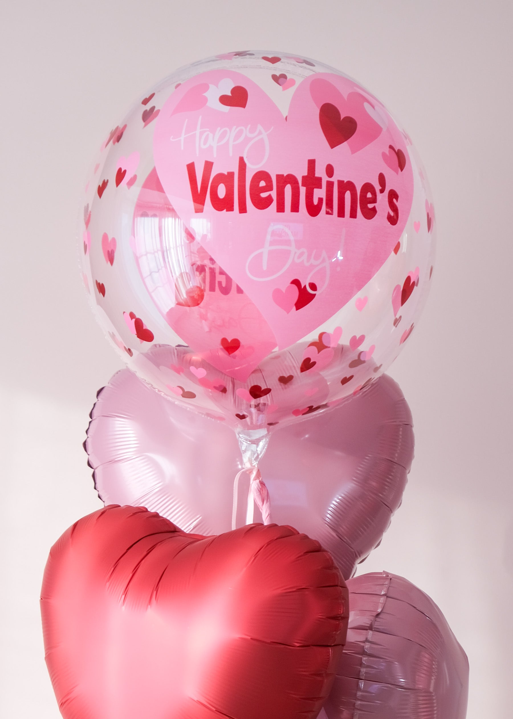 Clear bubble balloon with playful hearts 