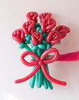 an arm holding an 8-stem twisted rose balloon bouquet