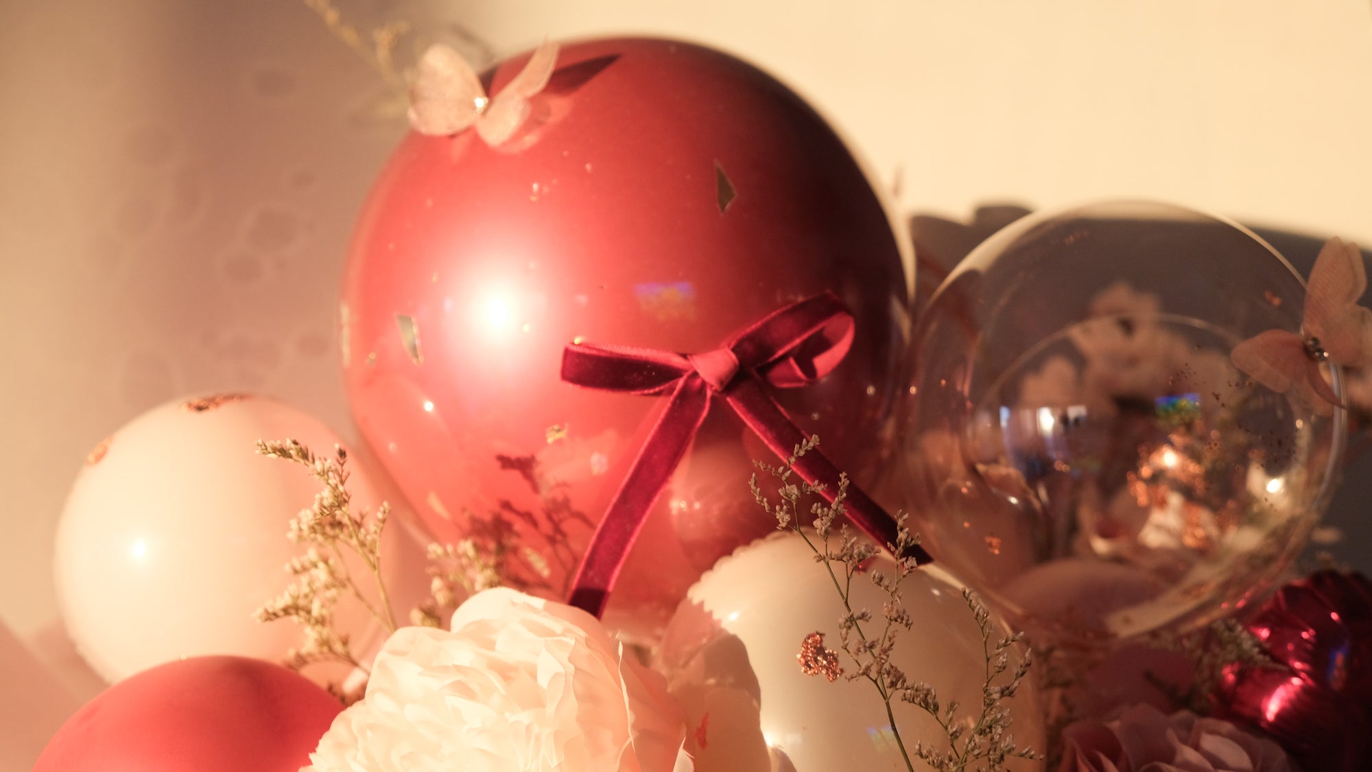 Decorative balloons with ribbons and floral details on a soft background
