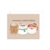 Christmas card with cartoon characters and 'warmest, coziest wishes' text on a beige background.