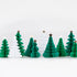 A set of green and white honeycomb shaped Christmas trees with gold foil stars on a white background.