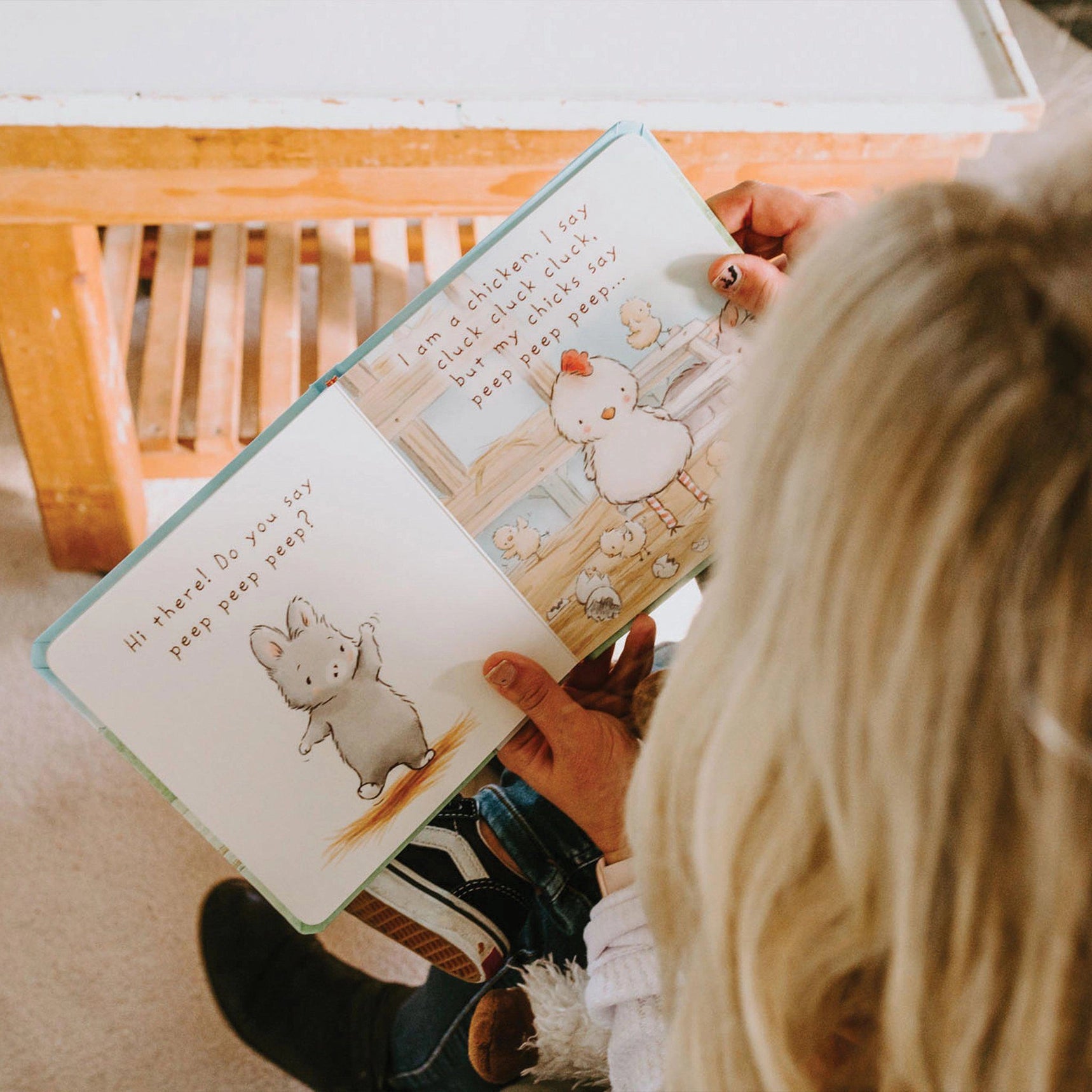 Child reading a children's book with cartoon animals