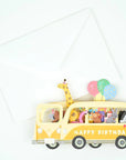 pop up 3d card featuring yellow bus with animals inside, "happy birthday" text on the side, and matching white envelope