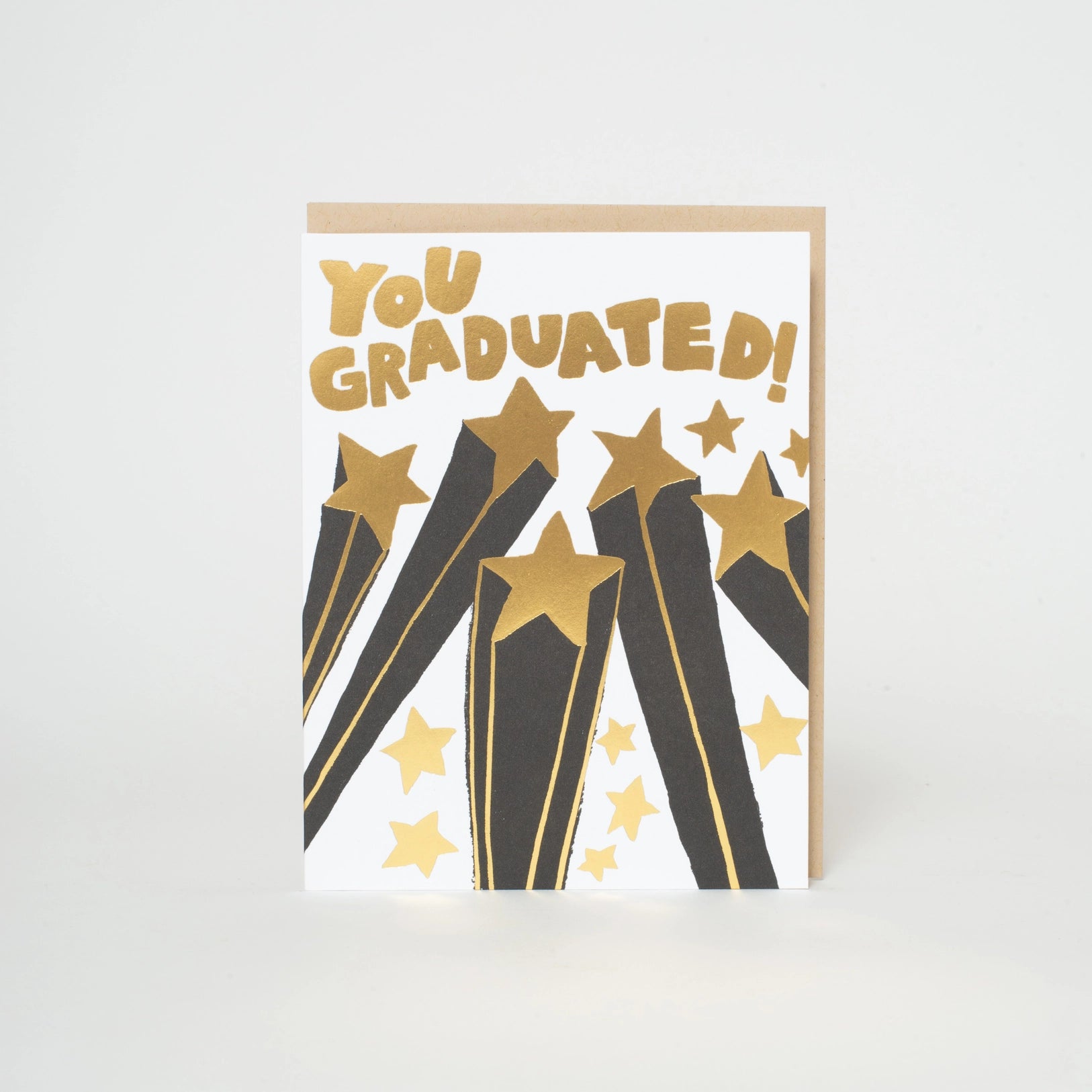 A greeting card with 'You Graduated!' text and star designs, letterpress printed in Portland, Oregon.