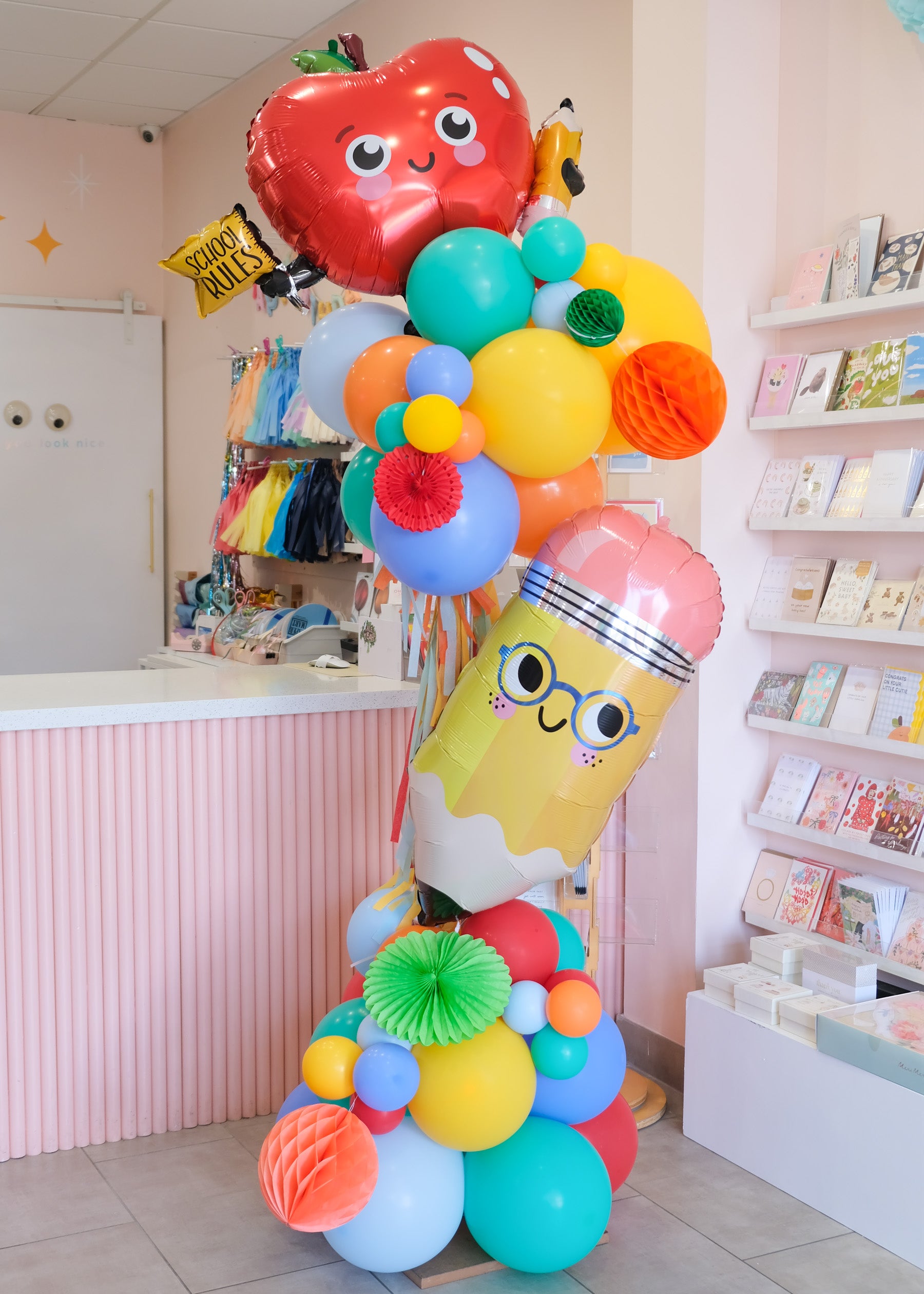 colorful balloon tower with school themed elements
