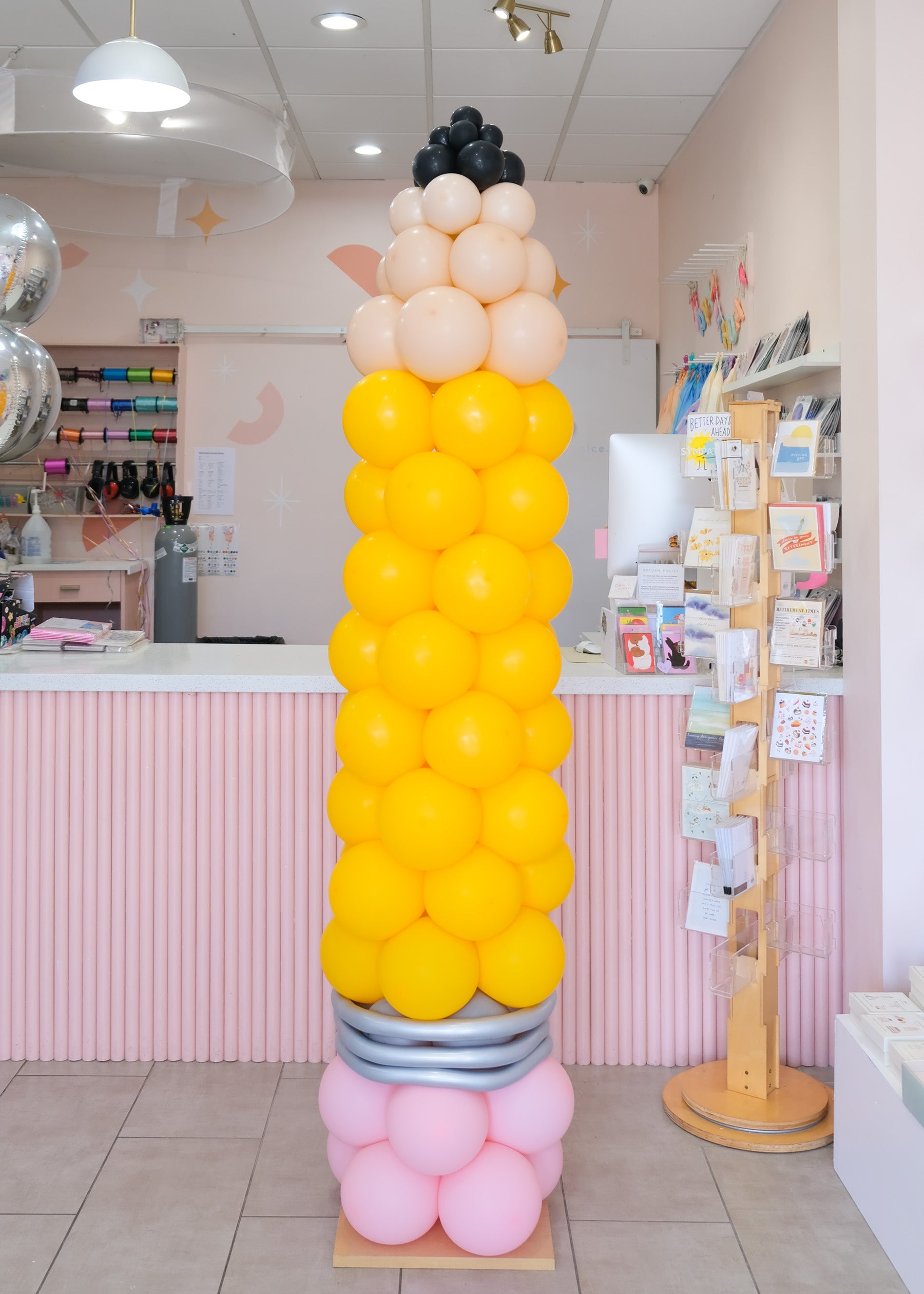 a 82" tall pencil balloon tower