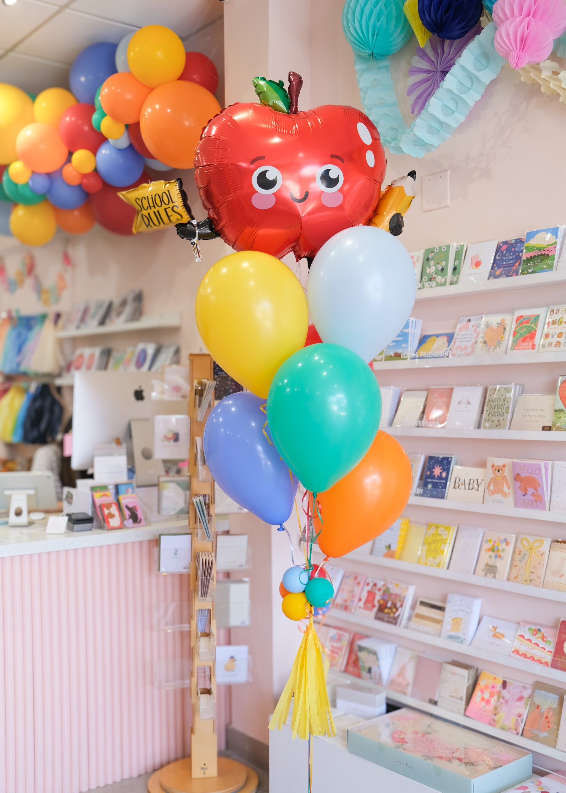 balloon bouquet featuring an apple balloon