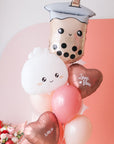 A balloon bouquet featuring a boba bubble tea character balloon, a dumpling with a heart face balloon, and a variety of other balloons in pink, red, and white colors with 'love you' and 'xoxo' decals.
