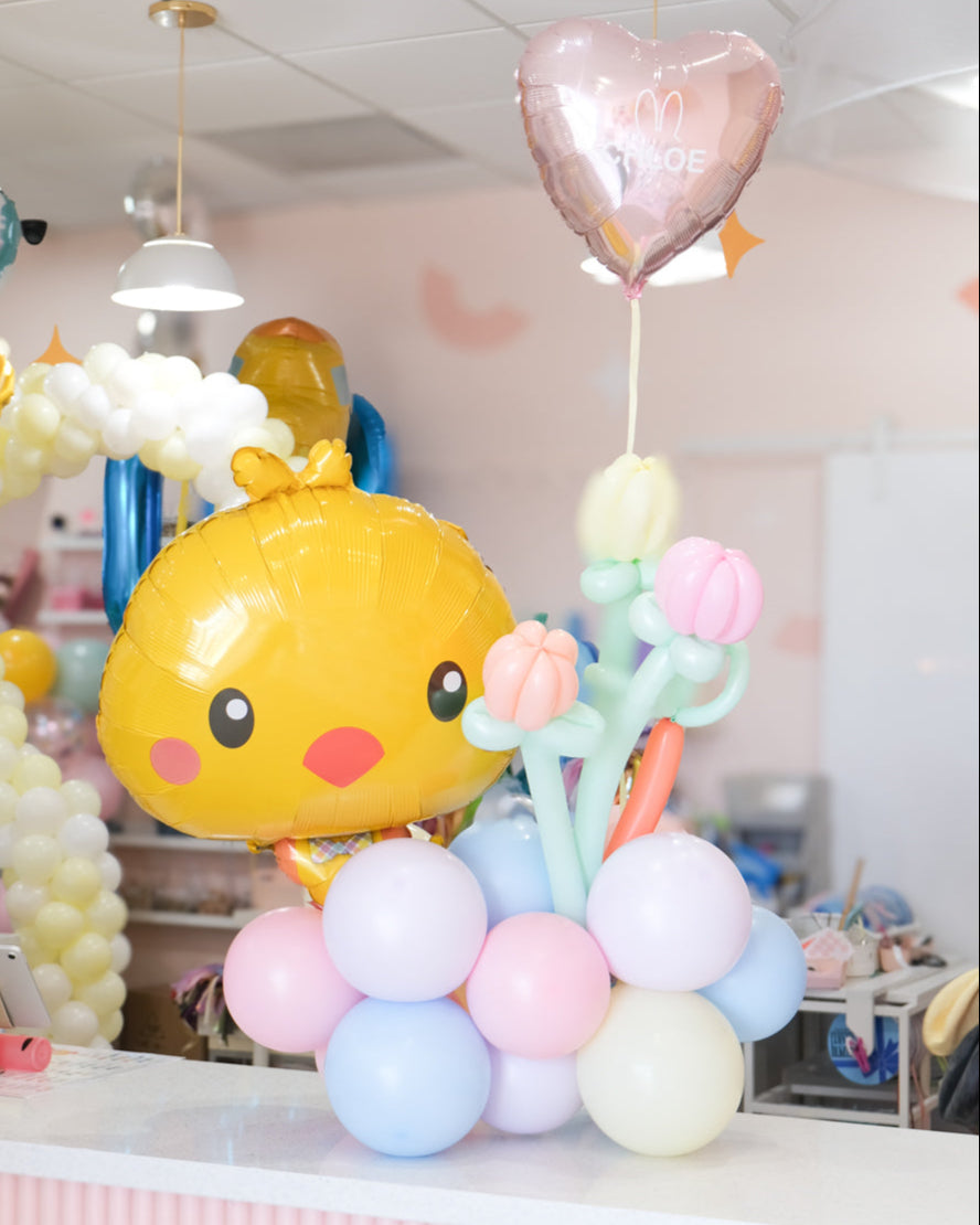 easter bunny balloon arrangement with balloon tulips sitting on a table counter in a store setting