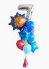 A balloon bouquet featuring a comic bubble shaped balloon with 'Happy Birthday' text, tied with other colorful balloons and decorative tassels.
