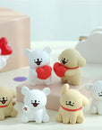Set of cute animal figurines with red hearts and collars on a light background