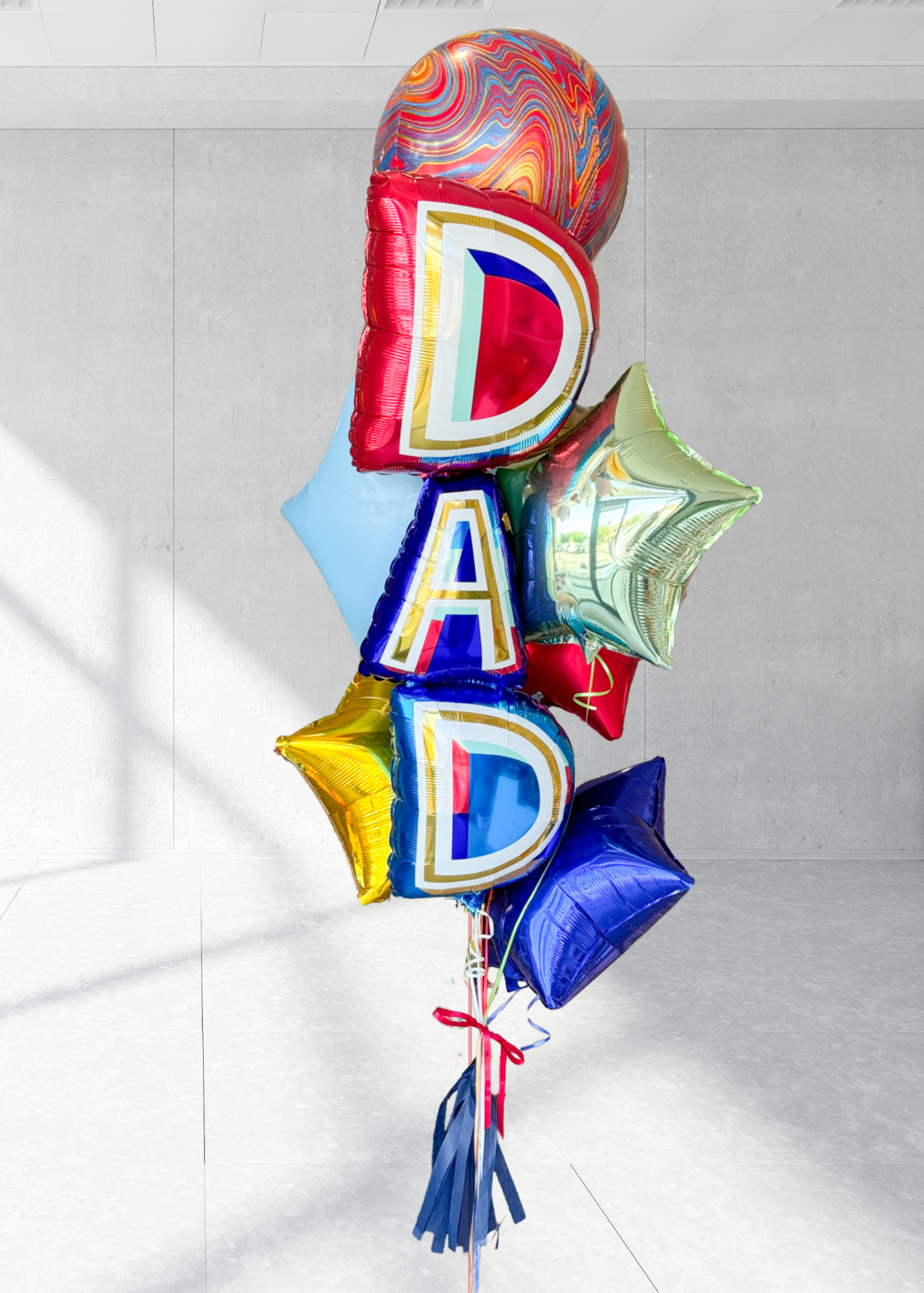 A bundle of Father's Day balloons with the word 'DAD' prominently displayed, featuring a variety of colors and decorations including stars and tassels.