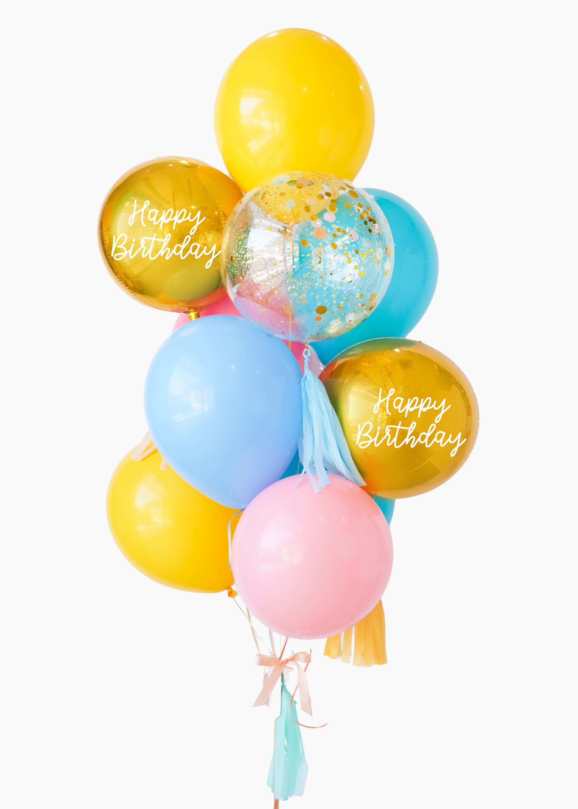 A balloon bouquet with a mix of solid colored balloons in blue, yellow, pink, and green, along with two metallic orb balloons, one with 'Happy Birthday' text, and a clear confetti balloon. There is a tassel and a ribbon bow on the arrangement.