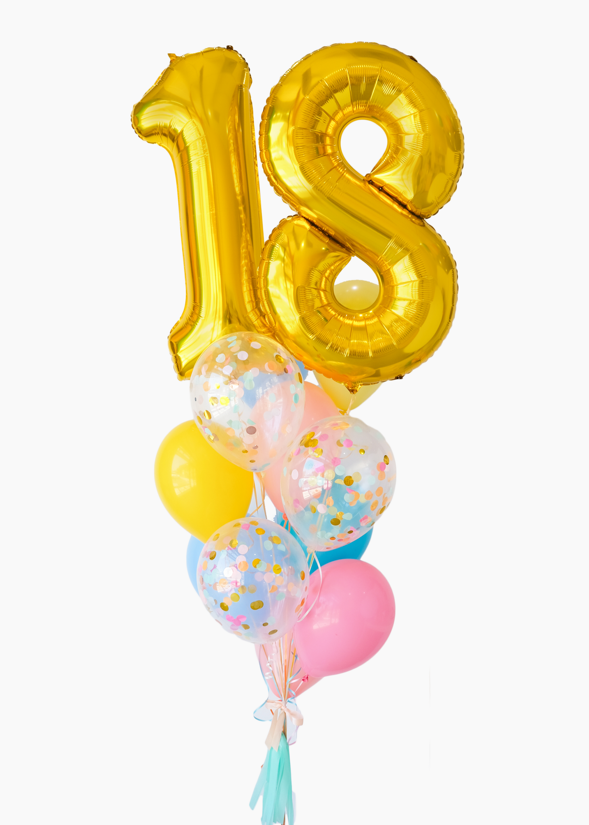 A balloon bouquet featuring a large gold number 18 balloon, with smaller multicolored balloons including pink, blue, and yellow, all adorned with confetti patterns. The balloons are attached to a ribbon bow and tassel.